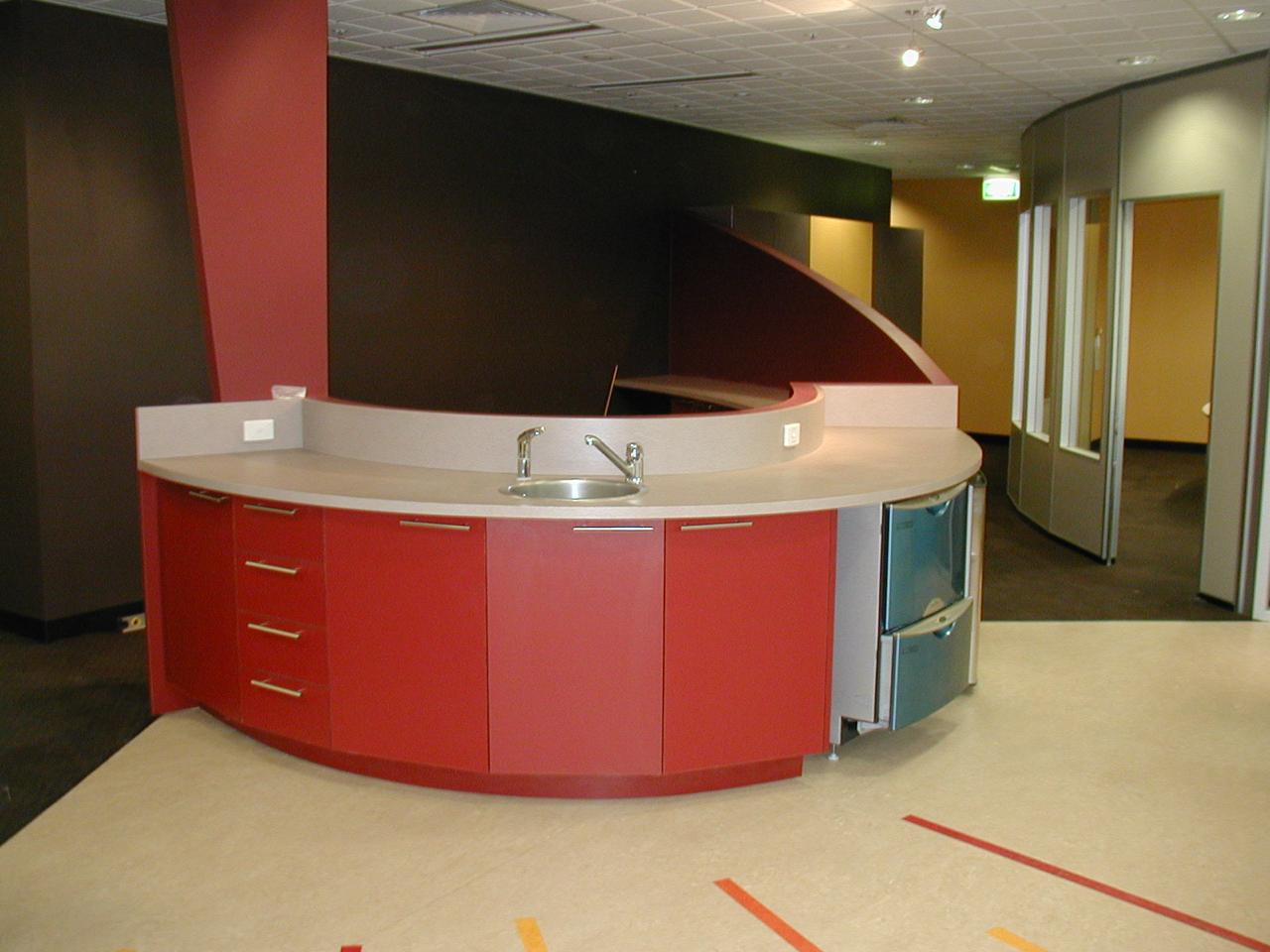 Curved office kitchenette joinery with integrated sink
